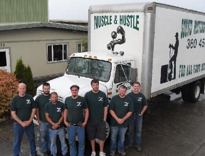 Sound Moving and Storage employees outside of a moving truck